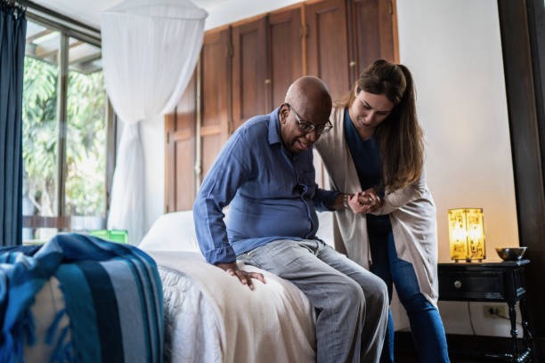 A senior being helped within a senior living home.